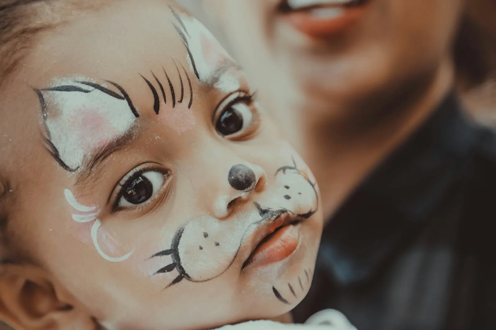 Child with tiger face paint